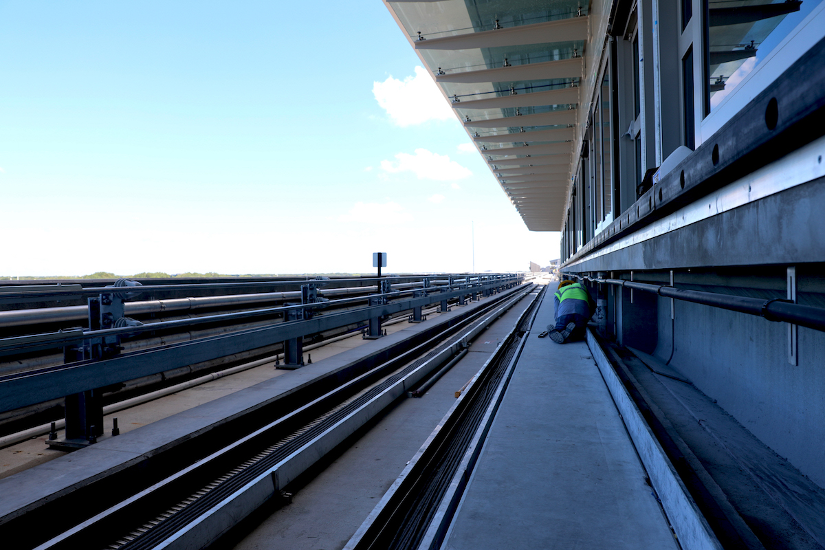 A worker works on the in progress SkyConnect track that's being built at Tampa International Airport